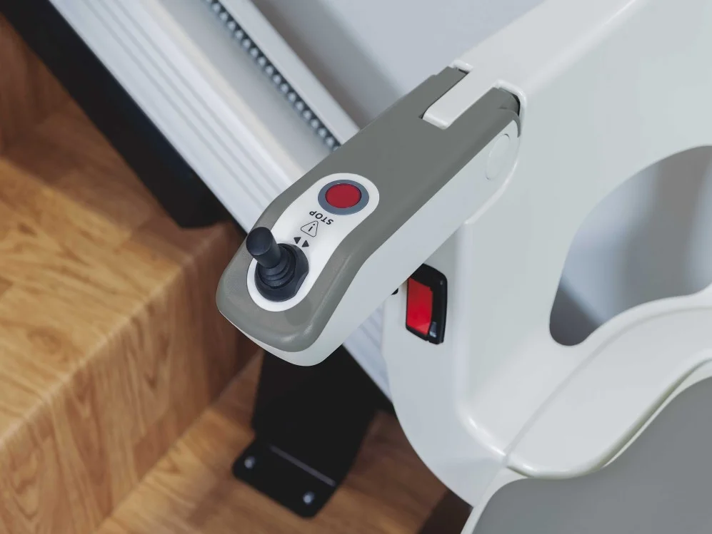 Panel de control con joystick y botón de parada de una silla salvaescaleras